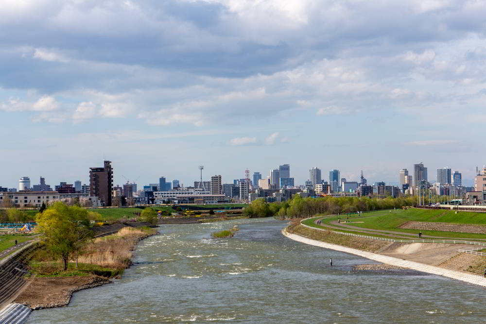 Blick von der München-Brücke in Sapporo mit der Skyline von Sapporo im Hintergrund.